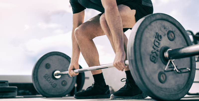 male athlete bending over lift to weight bar
