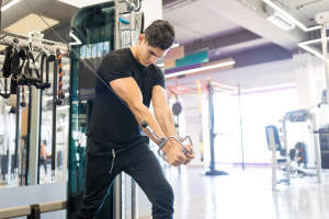 teen athlete strength training in a gym to gain muscle