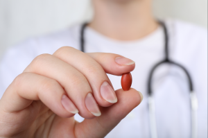 doctor holding an iron pill